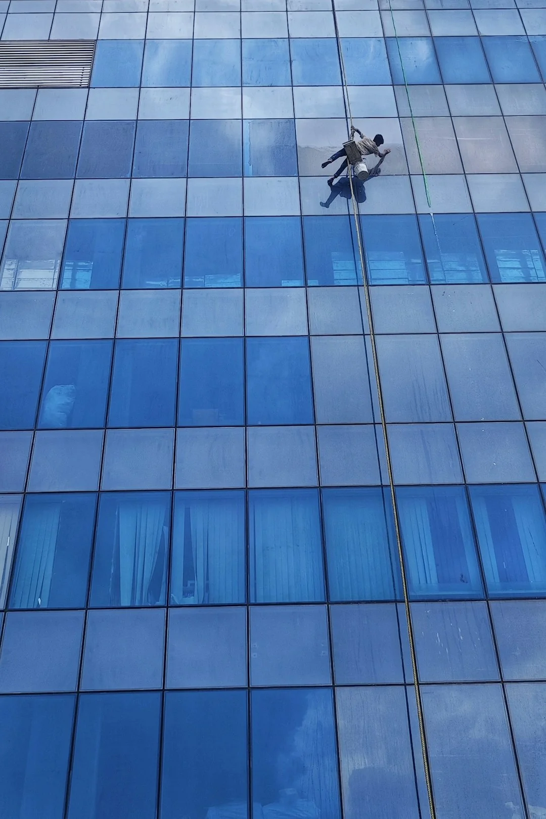 project-02-b High-rise glass facade with suspended platform for window cleaning.